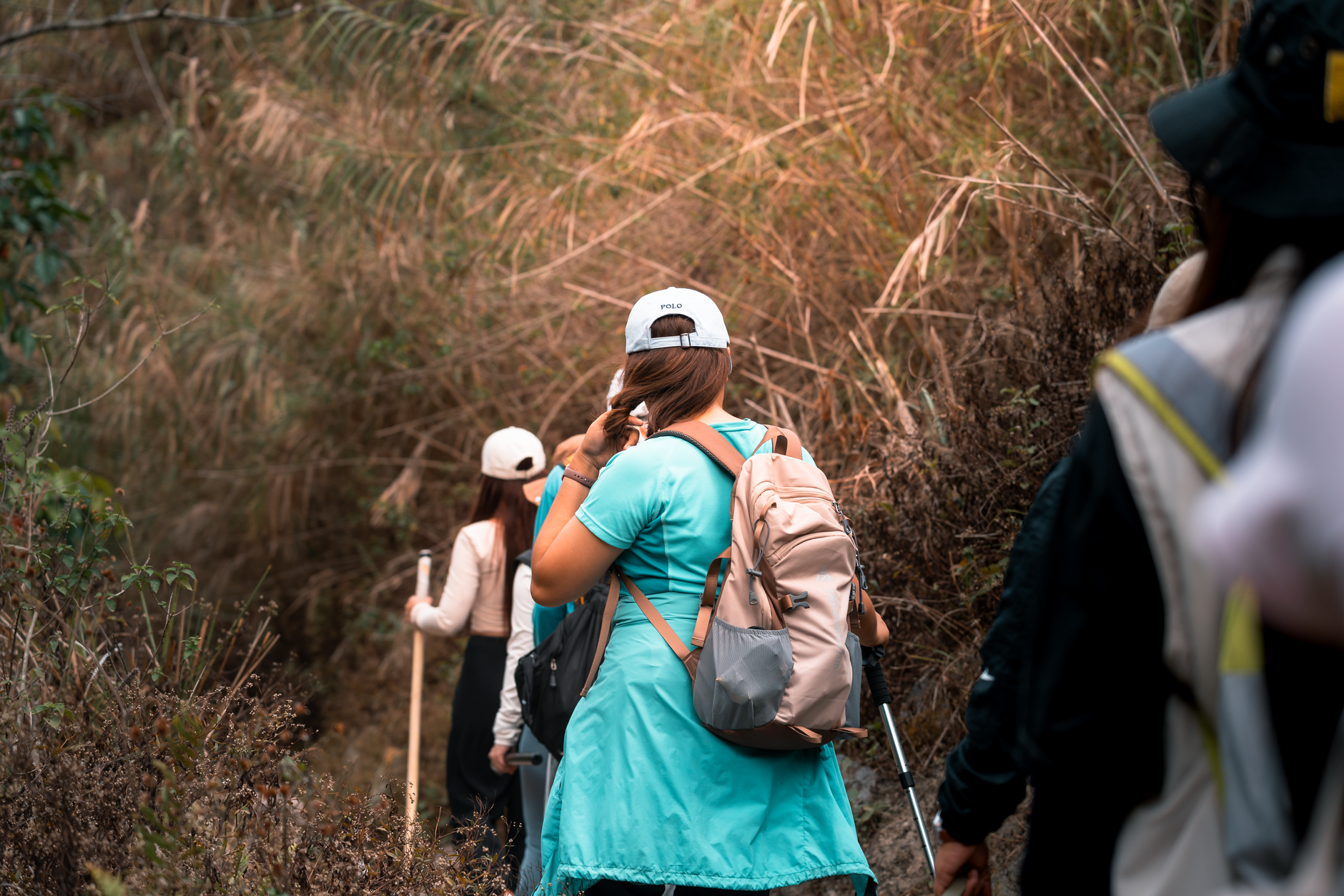 Group of women hiking through lush vegetation in Botolan, Philippines.