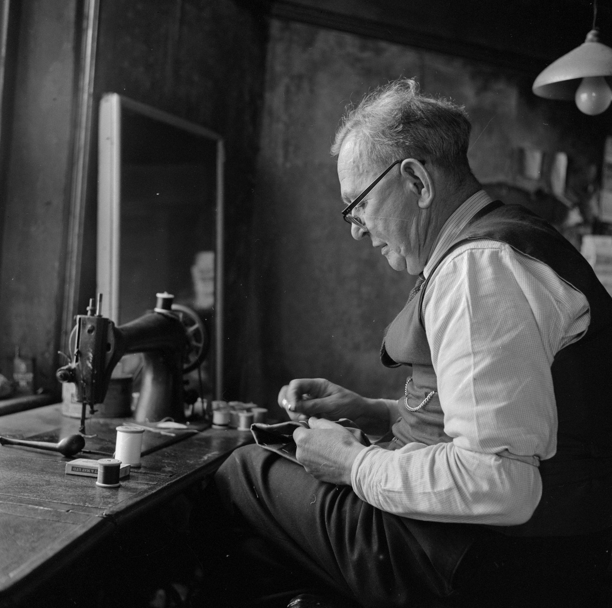 Evan Henry Williams, a country tailor from Langefni in his workshop